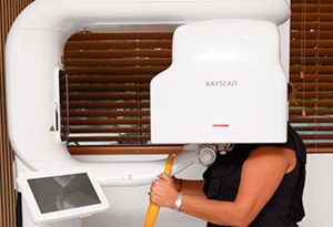 Patient receiving digital 3D dental scan with RAYSCAN imaging system at Murias Dental