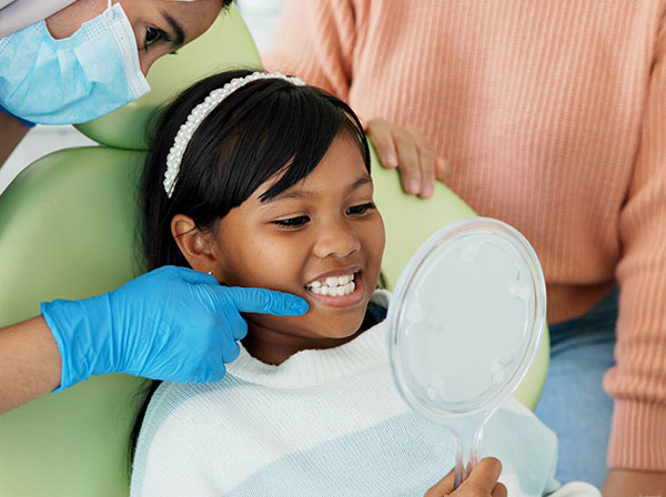 Kid’s dental check-up at Murias Dental with dentist guiding oral health and smile care